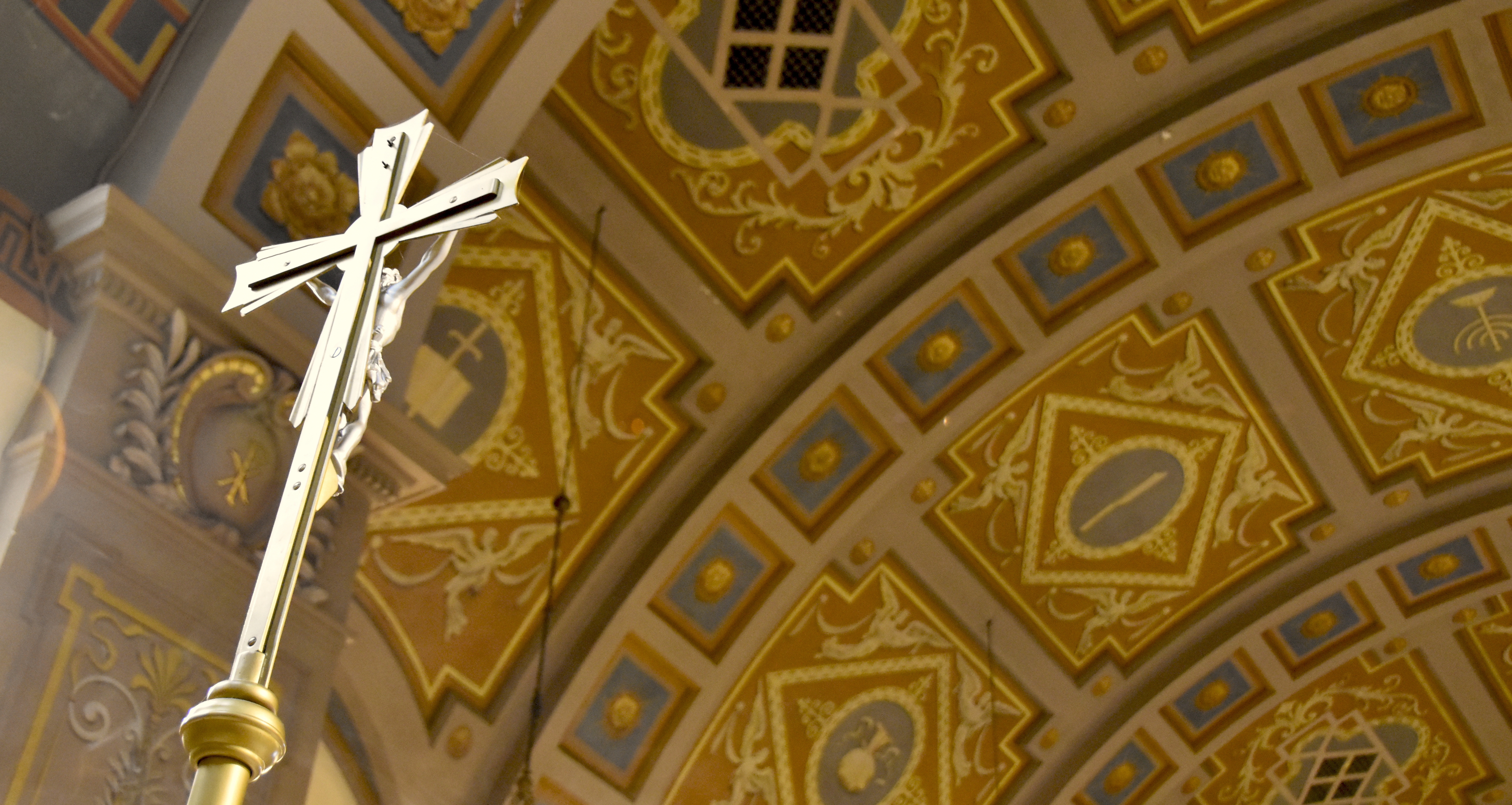 The ceiling of St Vincent de Paul Parish, and the processional crucifix.